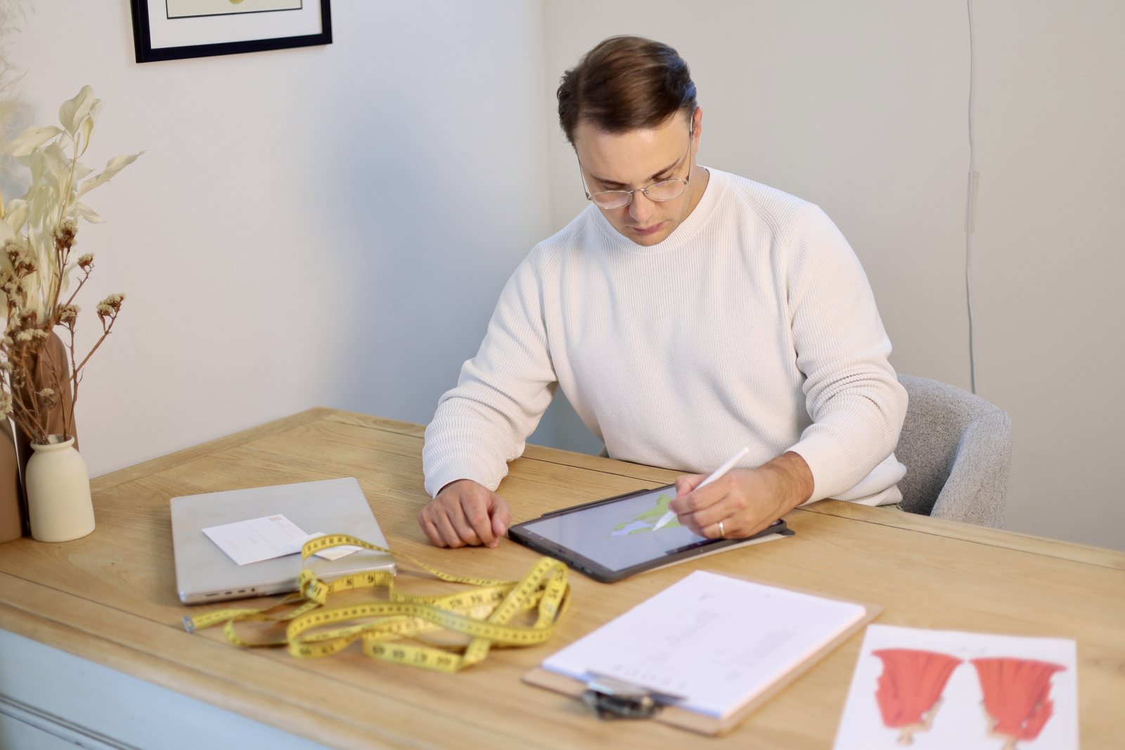 George Stander sketching at his desk in the atelier