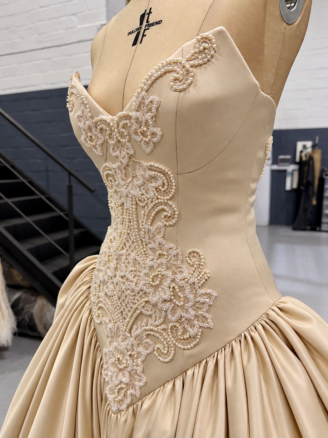 A Leocé couture bodice with hand-beaded lace on the dress form